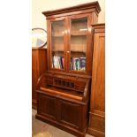 A 19th century mahogany cylinder bureau bookcase with glazed doors enclosing adjustable shelving
