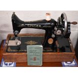 A 1930s vintage Singer sewing machine, c/w attachments and instruction book