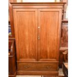 A Victorian mahogany linen press, the pair of panelled doors enclosing hanging rail and two slides
