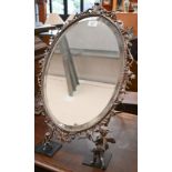 A good quality ep easel toilet mirror with oval bevelled plate in scrolling foliate frame