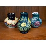 Three Moorcroft small vases, decorated with fruit and flowers, 9.5/8 cm high