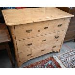 A large antique Continental pine chest of three long deep drawers with brass handles, raised on