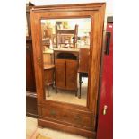 Continental 19th century walnut wardrobe with mirrored door enclosing hanging space, over single