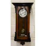 A Vienna style twin-train wall clock in glazed walnut and ebonised case c/w pendulum and key, 75