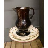 An 18th century black-glazed pottery ale jug, 17.5 cm to/w a floral-painted china dish and a