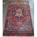A fine old Persian hand-made Bidjar carpet, the blue and red ground centred by a floral medallion,