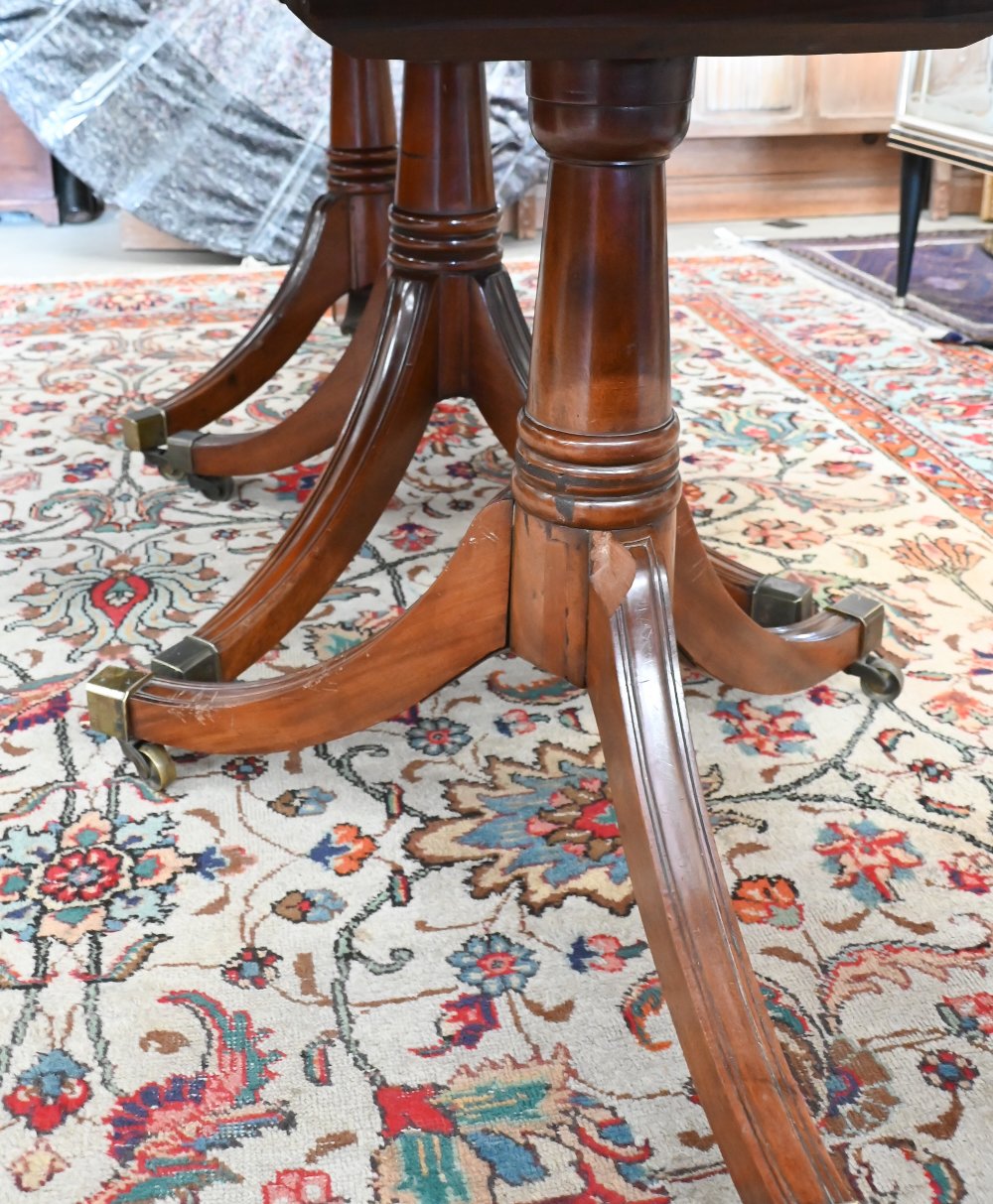 A 19th century mahogany extending dining table, the rounded rectangular top in three sections on - Image 4 of 5