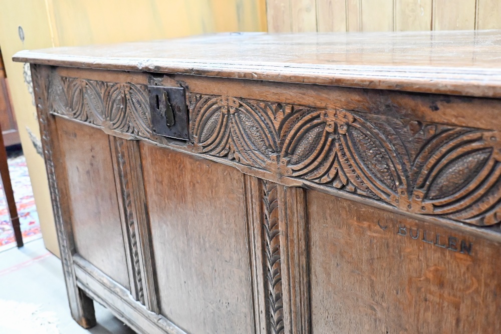 An antique carved and panelled oak coffer, 132 cm wide x 58 cm deep x 72 cm high - Image 4 of 5