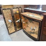 A Japanese gilt and black lacquered two door cabinet decorated with red crowned cranes (Tswu), 82 cm