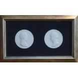 A framed pair of Berlin porcelain medallions commemorating Wilhelm & Alexander von Humboldt; each