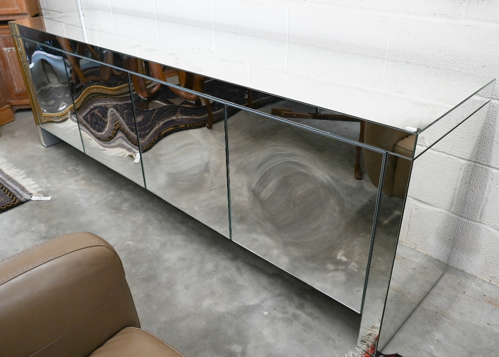 An Italian Porada Empire mirrored sideboard designed by Gino Carrollo with four concave push-to-open