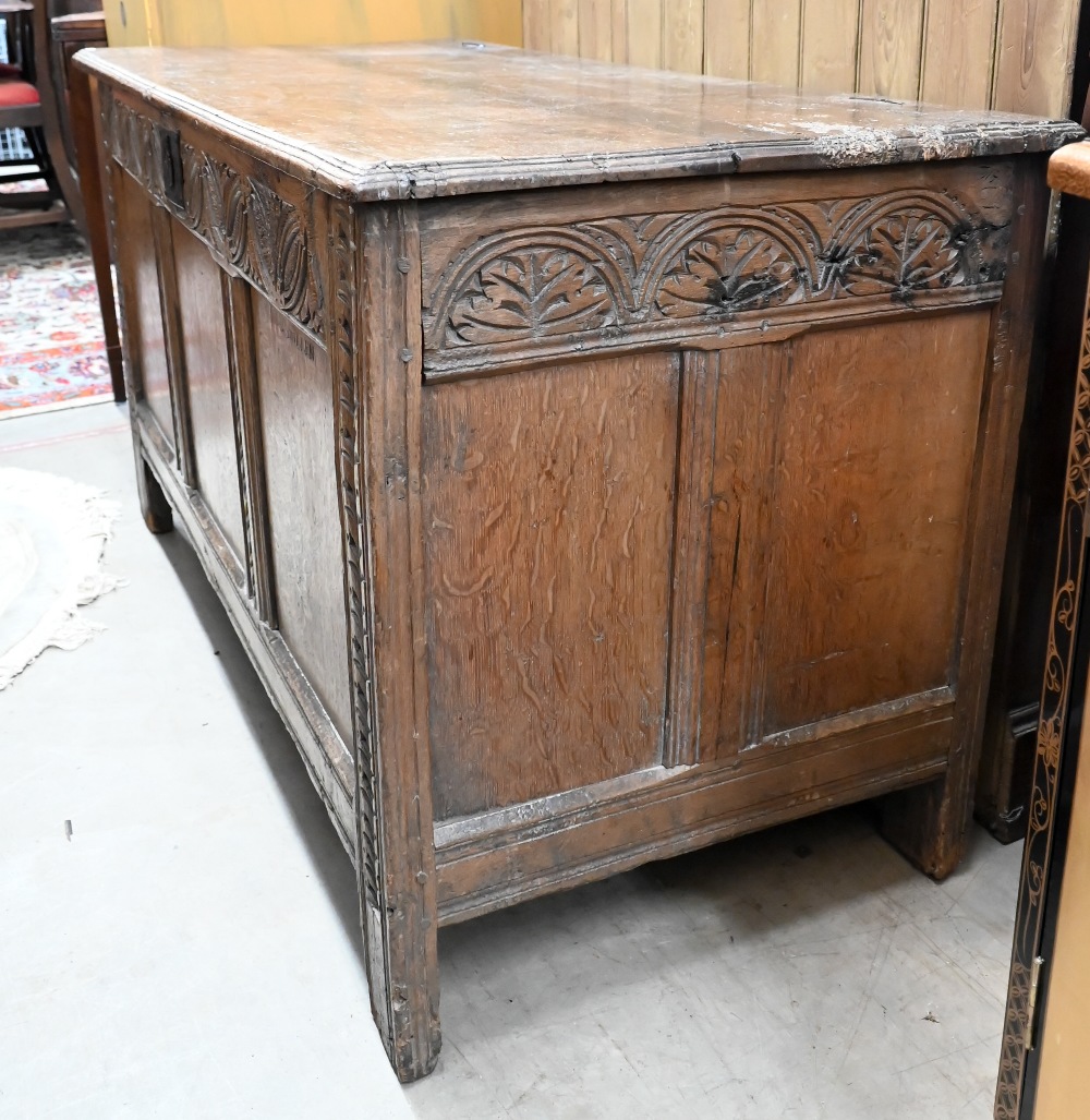 An antique carved and panelled oak coffer, 132 cm wide x 58 cm deep x 72 cm high - Image 3 of 5