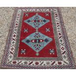 Two Turkish handmade rugs, geometric design on brown-red ground, 160 x 152 and 109 x 85 cm (2)