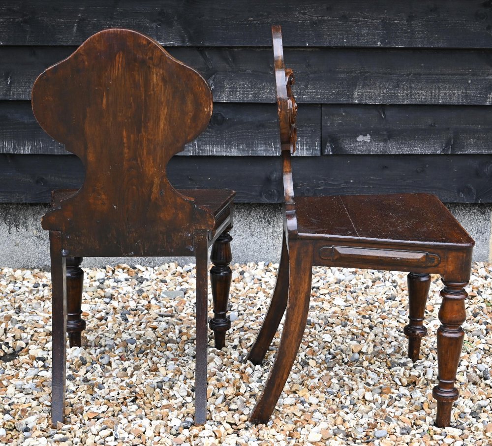 A pair of Victorian armorial carved oak hall chairs with panelled seats and turned front legs (2) - Image 2 of 4