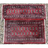 A Tekke Bokhara red ground rug with repeating gul design, 157 cm x 94 cm to/w a Tekke Bokhara