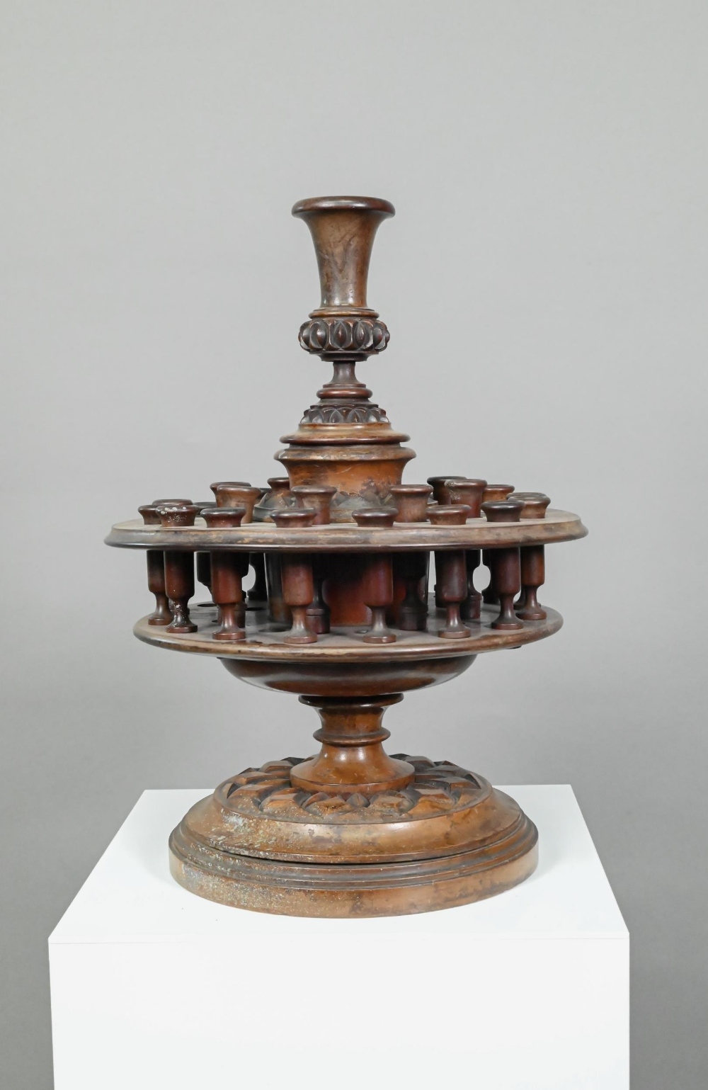 An antique carved and turned wood snuff or tobacco stand with sectional central pillar surrounded by