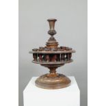 An antique carved and turned wood snuff or tobacco stand with sectional central pillar surrounded by