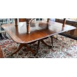 A 19th century mahogany extending dining table, the rounded rectangular top in three sections on