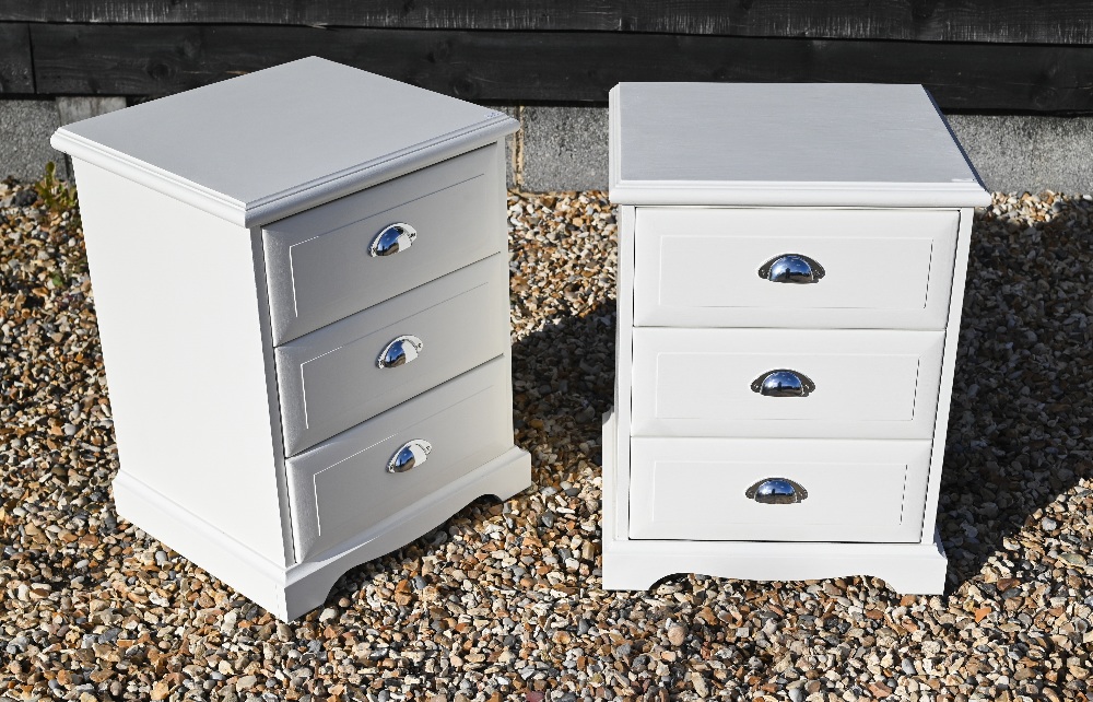 A pair of white painted three drawer bedside chests with chromed cup handles (2)