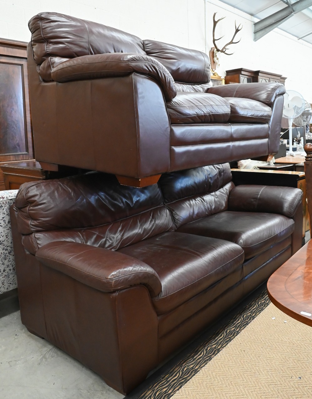 A brown leather two seater sofa, 180 cm w x 95 cm d x 95 cm h, to/w a matching three seater sofa,