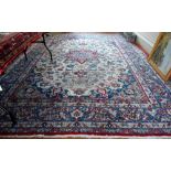 An antique Persian hand-made Isfahan carpet, the ivory field centred by a floral medallion and