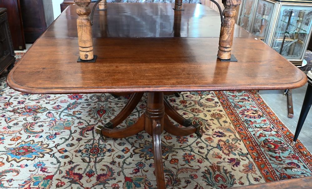 A 19th century mahogany extending dining table, the rounded rectangular top in three sections on - Image 3 of 5