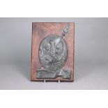 A 19th century tin insurance plaque embossed with phoenix over 'Protection', on oak plaque 31 x 22