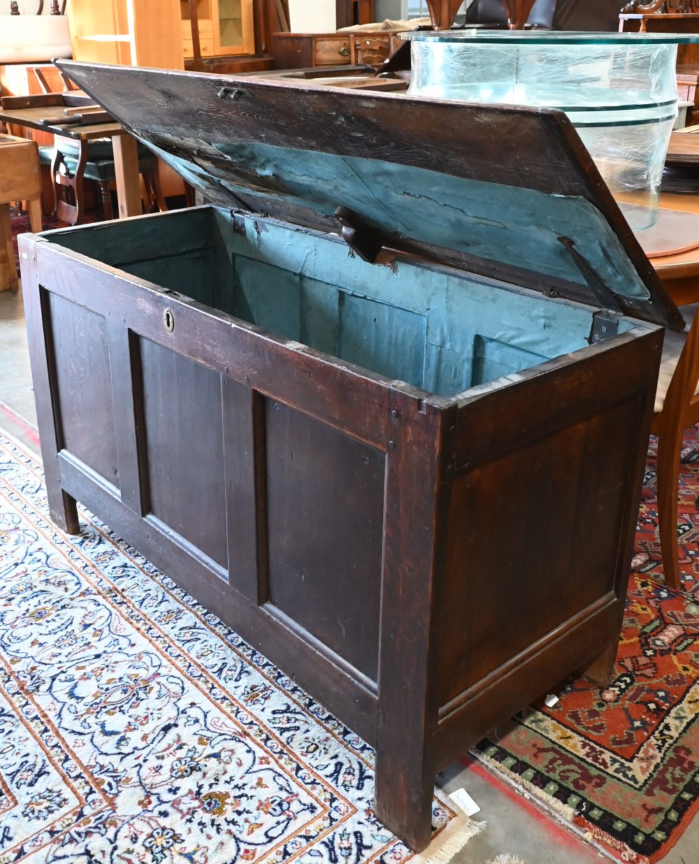 A large antique panelled oak coffer, hinged top enclosing the deep storage area, 138 cm wide x 56 cm - Image 3 of 5