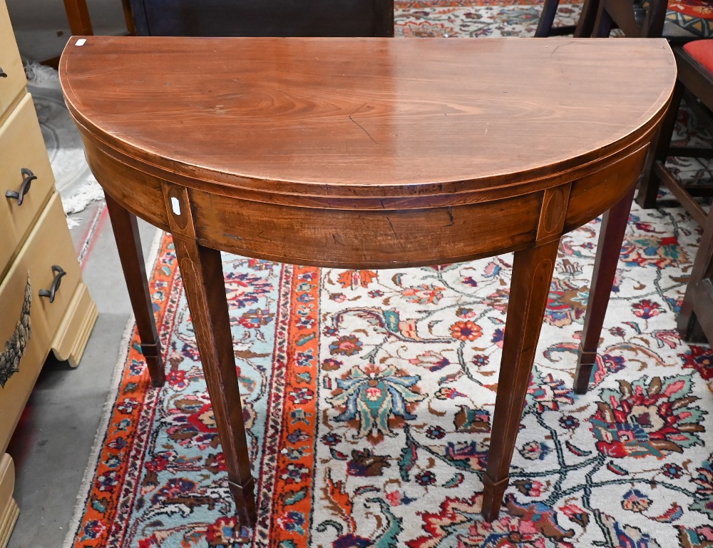 A 19th century mahogany demi-lune tea table on tapering square supports with tall spade feet, 90
