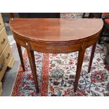 A 19th century mahogany demi-lune tea table on tapering square supports with tall spade feet, 90