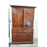 A 19th century mahogany wardrobe (converted from a linen press) with panelled doors enclosing