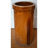 A cylindrical stoneware amber-glazed umbrella/stick stand, 49 cm high