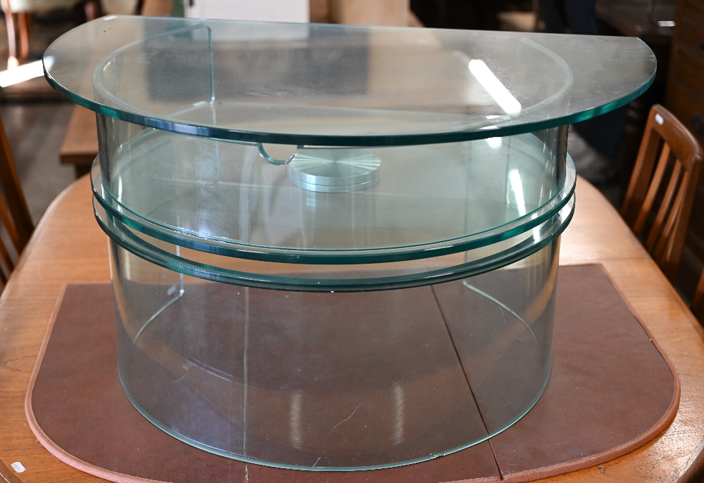 A contemporary glass revolving media unit/TV stand, 82 cm wide x 43 cm high