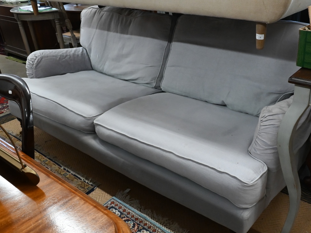 A Howard style three seater sofa, turned mahogany front legs with brass castors, pale blue - Image 3 of 3