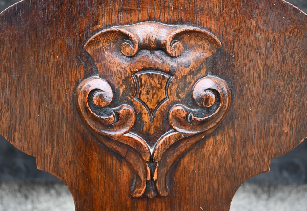 A pair of Victorian armorial carved oak hall chairs with panelled seats and turned front legs (2) - Image 3 of 4