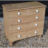 A waxed pine chest of two short over three long drawers with white crackle-glazed ceramic handles