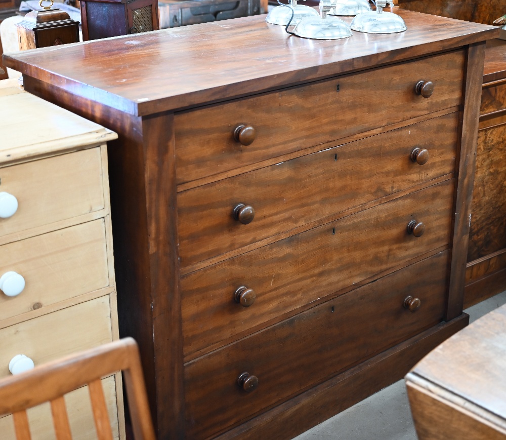 A large Victorian mahogany chest of four long graduating drawers with turned handles, raised on