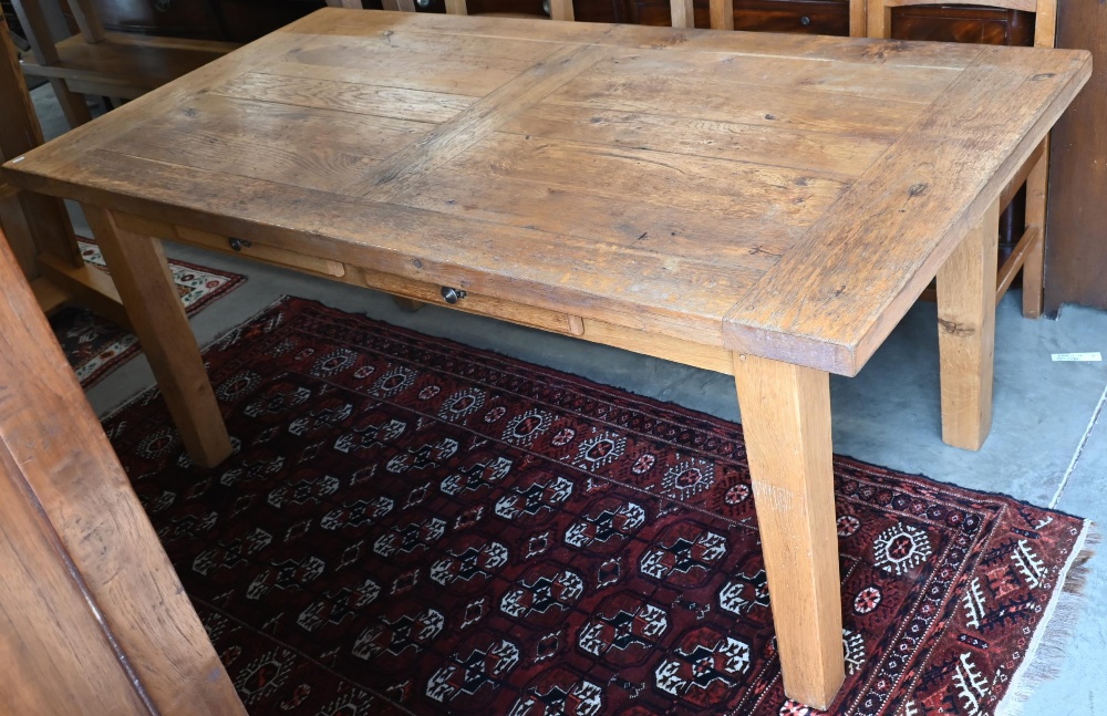 A provincial French oak dining table with cleated rectangular top raised on square leg, 180 x 90 x