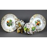 A pair of Meissen wall-plates, finely painted with fruit and flowers, within pierced basketwork