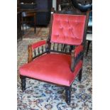 An Edwardian stained and carved walnut armchair, red dralon button back upholstery