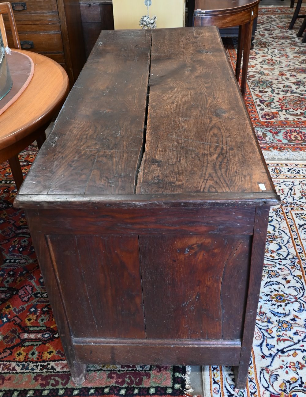 A large antique panelled oak coffer, hinged top enclosing the deep storage area, 138 cm wide x 56 cm - Image 5 of 5
