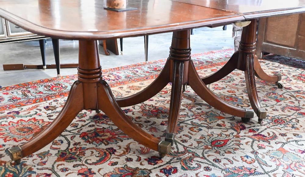 A 19th century mahogany extending dining table, the rounded rectangular top in three sections on - Image 2 of 5