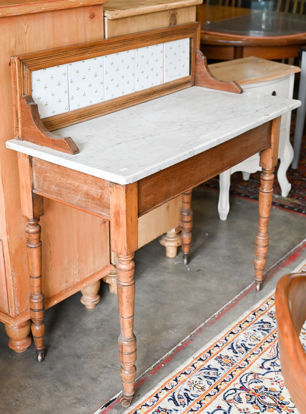 An Edwardian stained beech wash stand with white marble top with tiled gallery, 92 cm w x 43 cm d