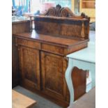A Victorian burr walnut chiffonier with two drawers over arched platform cupboard doors raised on