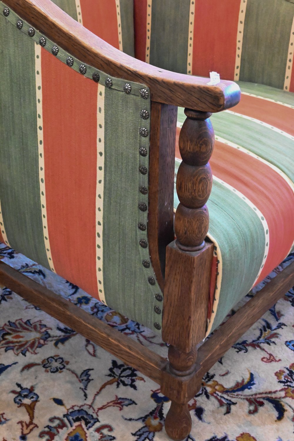 An early 20th century oak framed armchair with green and red striped fabric uphostery - Image 2 of 3