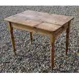An old stripped pine kitchen table with single drawer to one end, raised on turned legs, 101 cm x 66