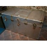 A vintage rivetted aluminium flight trunk with leather handles and fabric lined interior