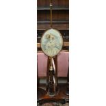 A Regency rosewood pole screen, the adjustable rise and fall pole with needlepoint panel on a