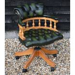 A modern green leather button back revolving captain's chair