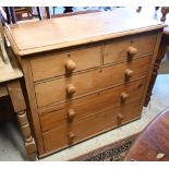 An antique pine chest of two short over three long drawers having turned handles, 100 cm wide x 45